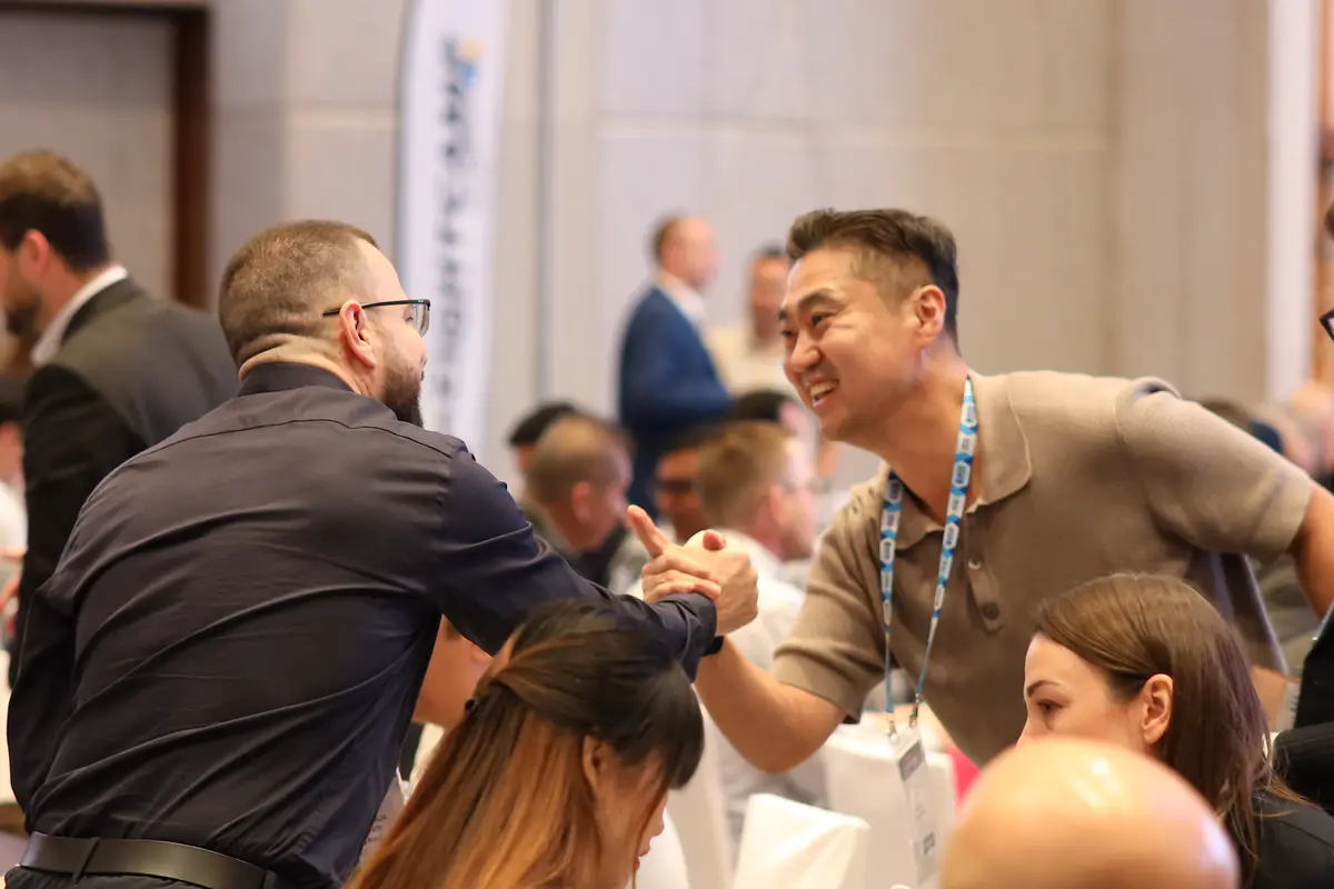 Two freight forwarders greeting each other at Freightcamp Bangkok 2025